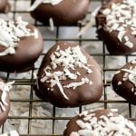 Copycat Cadbury creme easter eggs on a cooling rack, sprinkled with extra coconut.