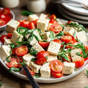 A plate of vegan caprese salad, ready to serve.