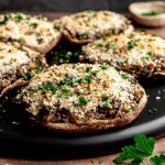 A tray of stuffed portobello mushrooms.