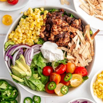 A vegan taco bowl loaded with toppings.