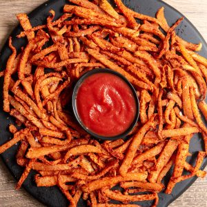 Oil-Free Jicama fries on a serving tray with ketchcup.