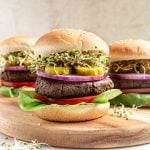 A vegan high protein seitan burger on a cutting board.