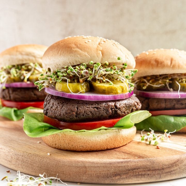 A vegan high protein seitan burger on a cutting board.