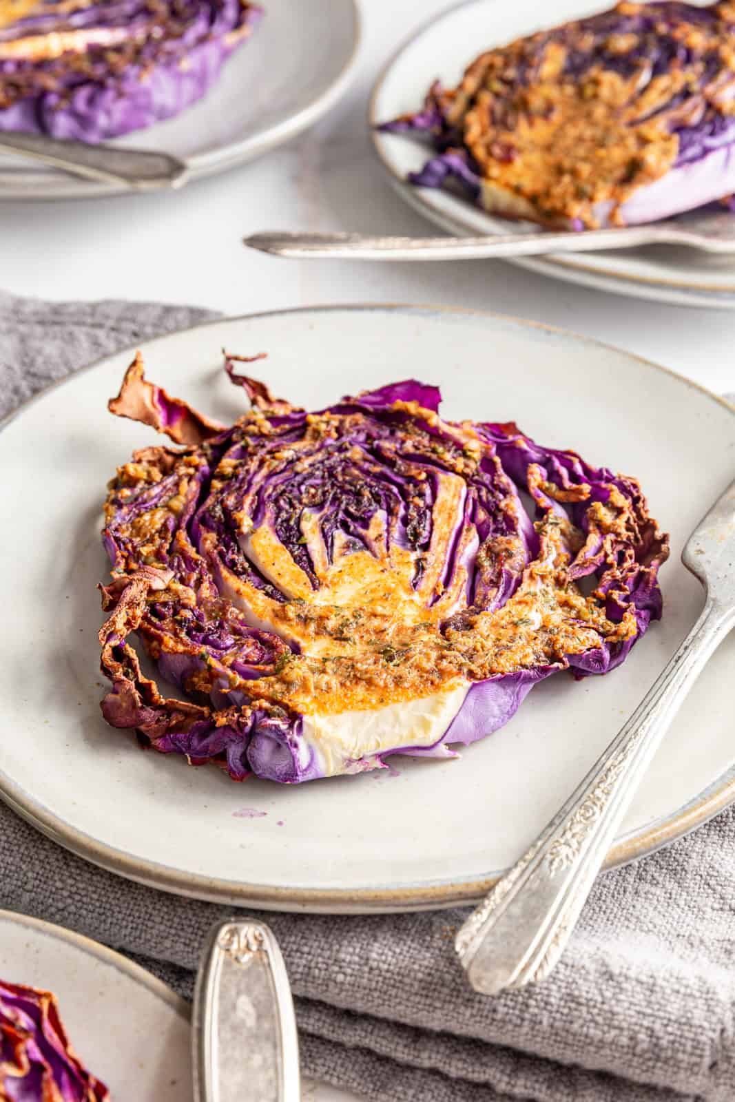 Red cabbage steaks served on plates.