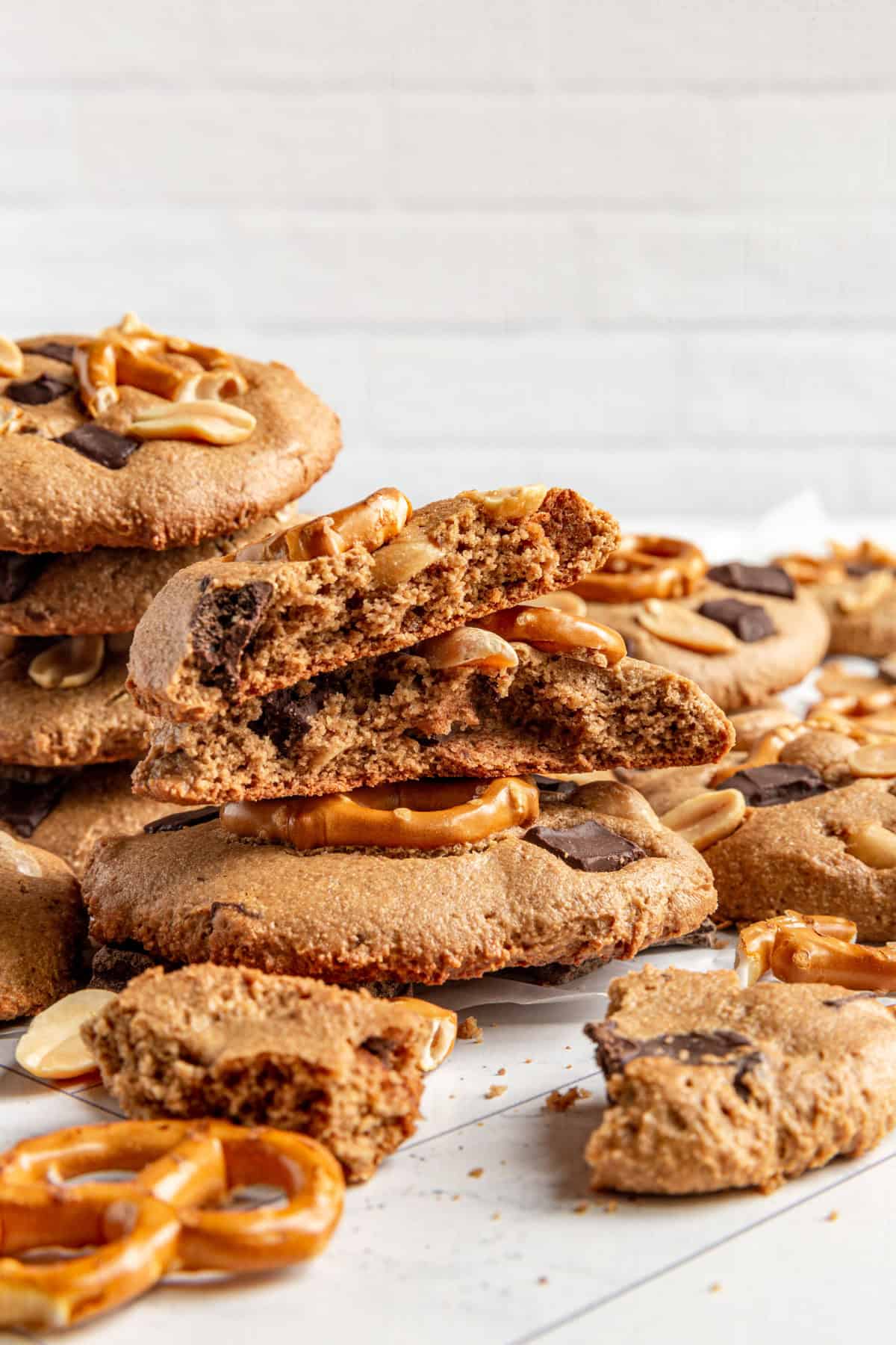 A pile of vegan kitchen sink cookies with extra toppings surrounding them.