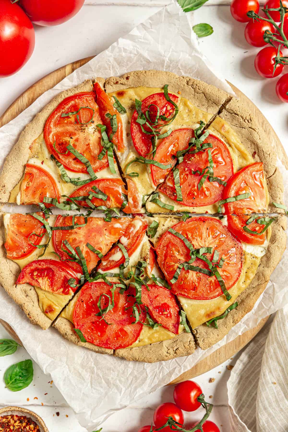 A whole Vegan Margherita Pizza, sliced and ready to eat.
