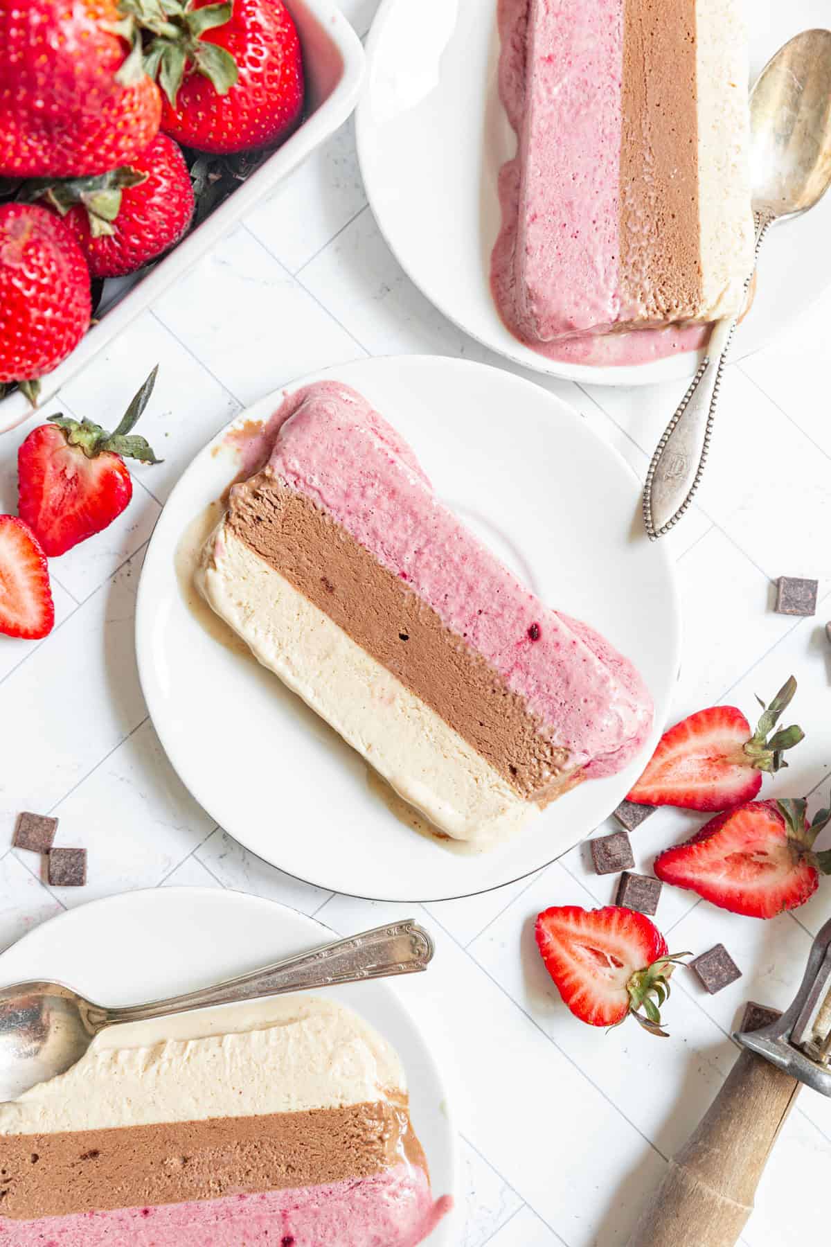 Three plates of Vegan Neapolitan Ice Cream slices.