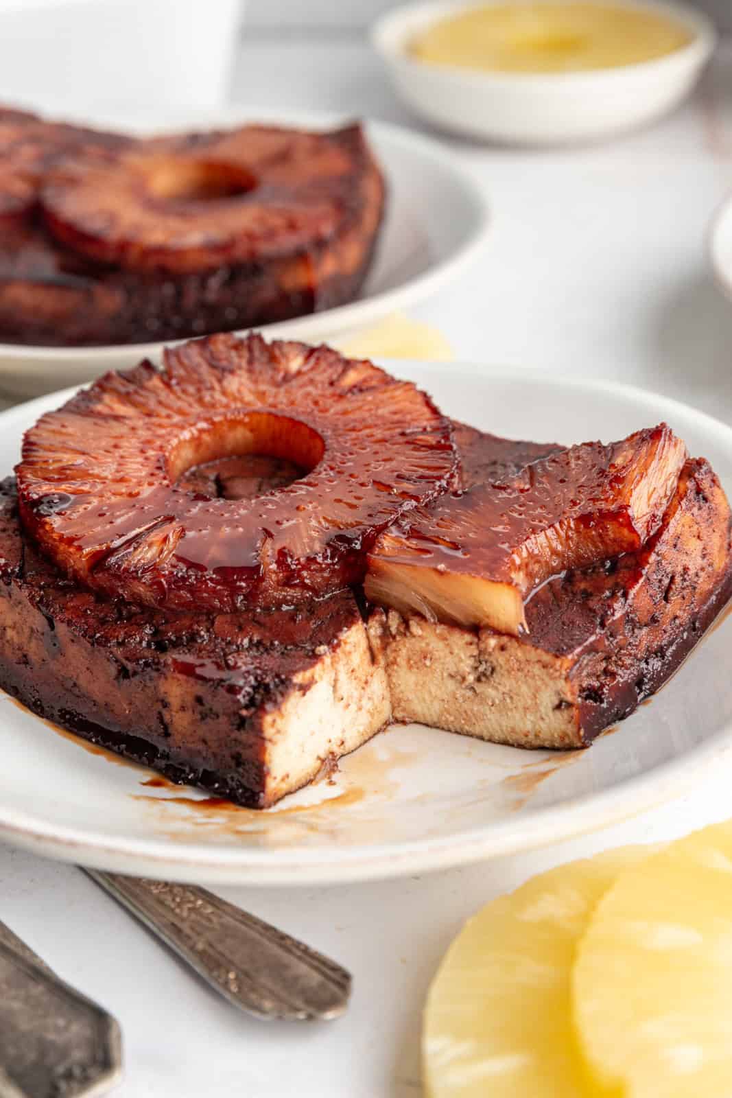 A slice of Pineapple Glazed Tofu with a bite taken.