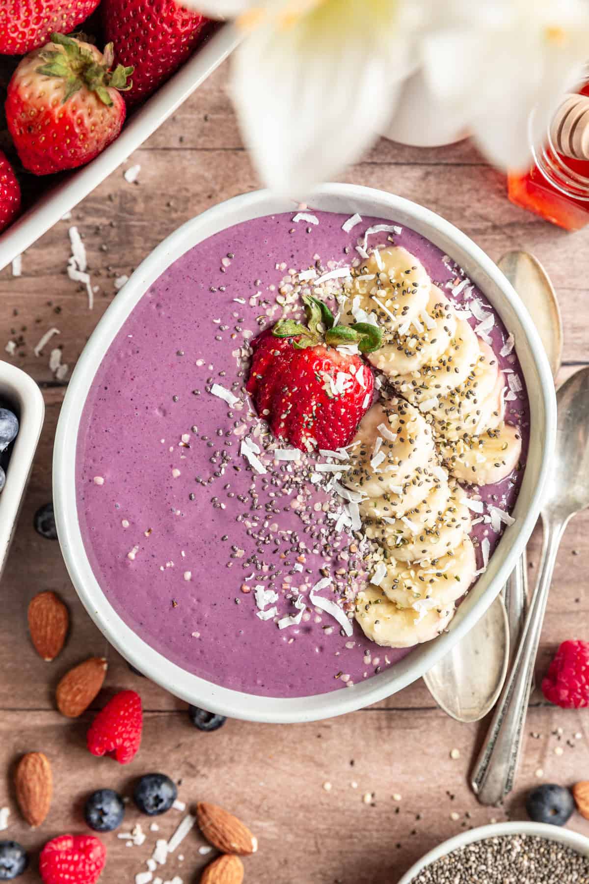 High Protein Acai Smoothie Bowl topped with strawberries, banana, and coconut.