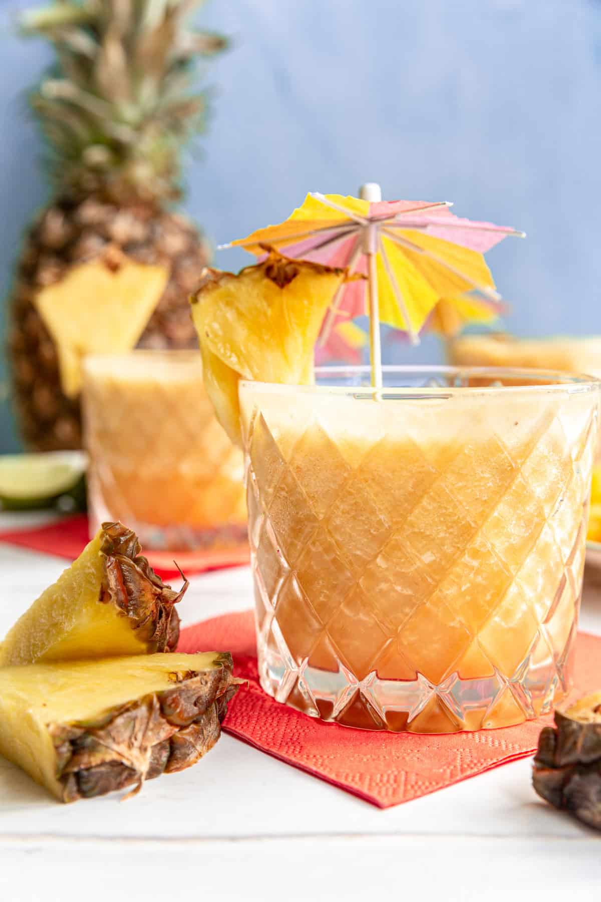 A Piña Colada Mocktail with a garnish of pineapple and a tiny umbrella.