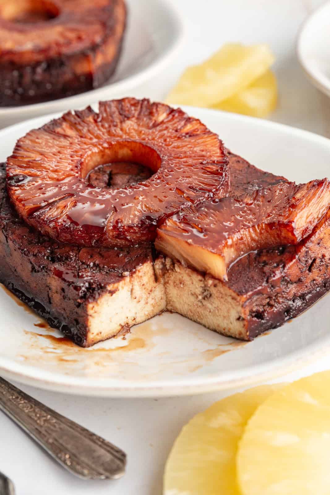 A slice taken out of a block of Pineapple Glazed Tofu.