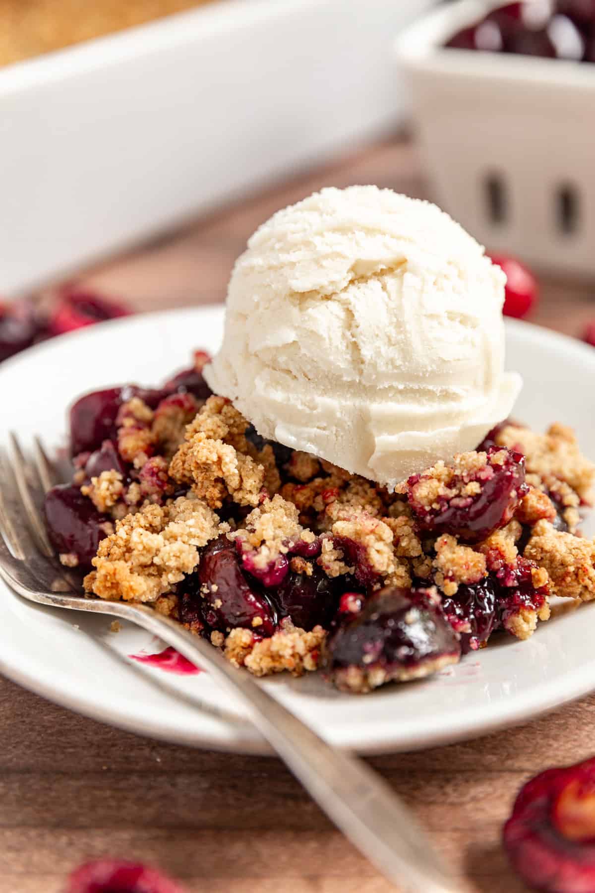 Vegan Cherry Crumble served with a scoop of ice cream.