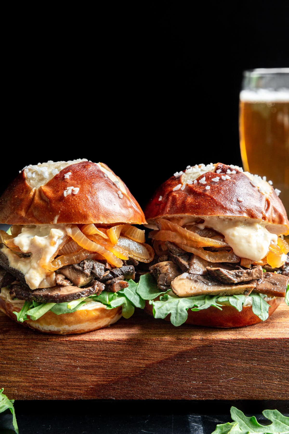 Two Portobello Mushroom Sliders on a cutting board.