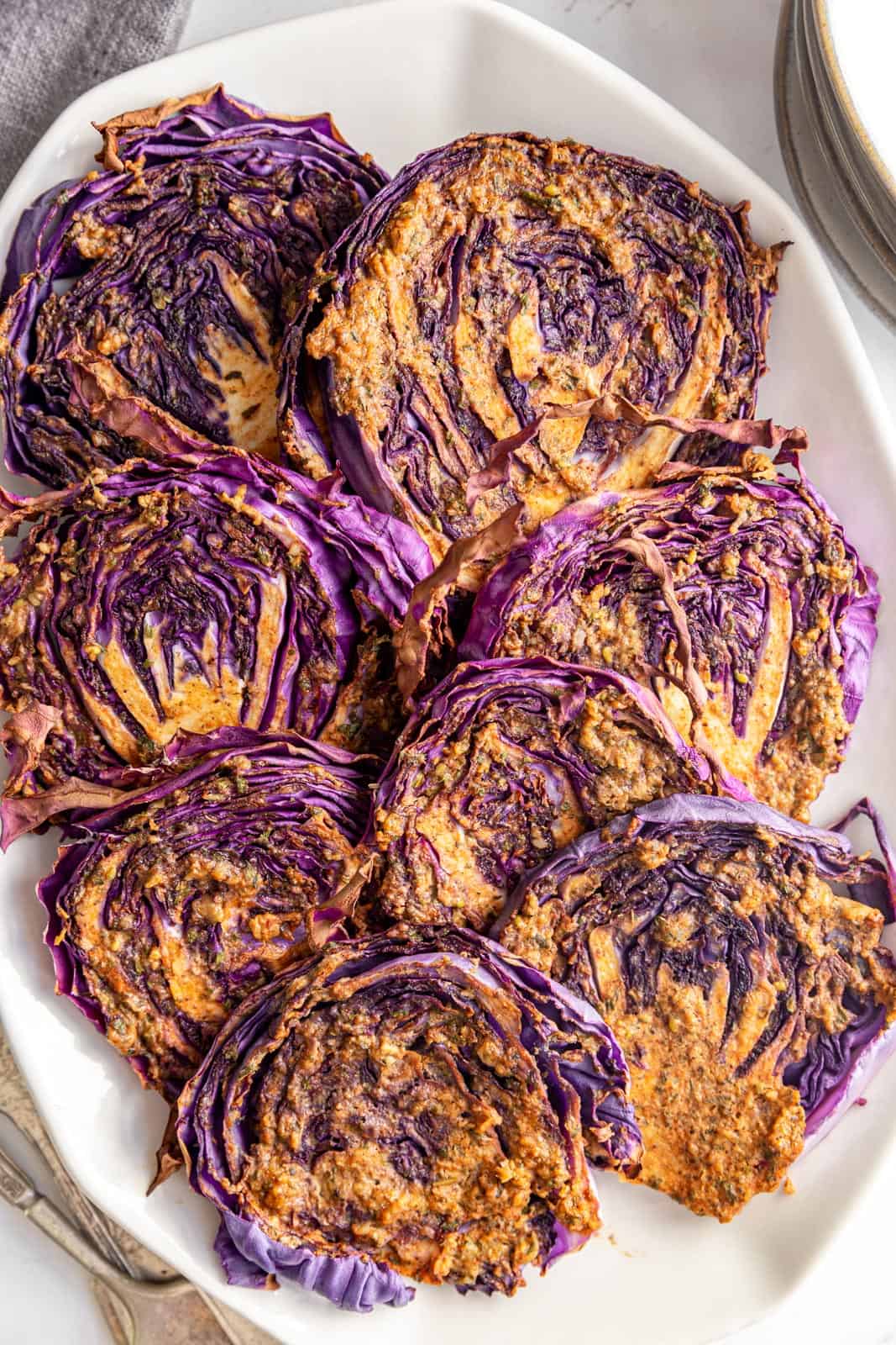 Red Cabbage Steaks arranged on a platter.