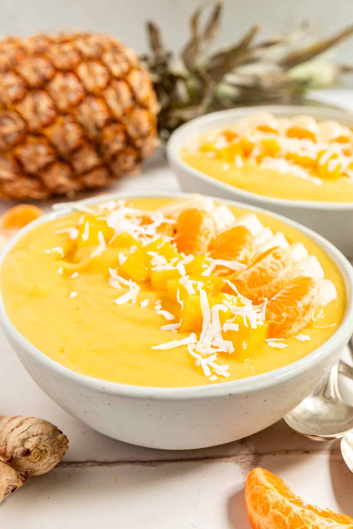 A tropical smoothie bowl and a pineapple.