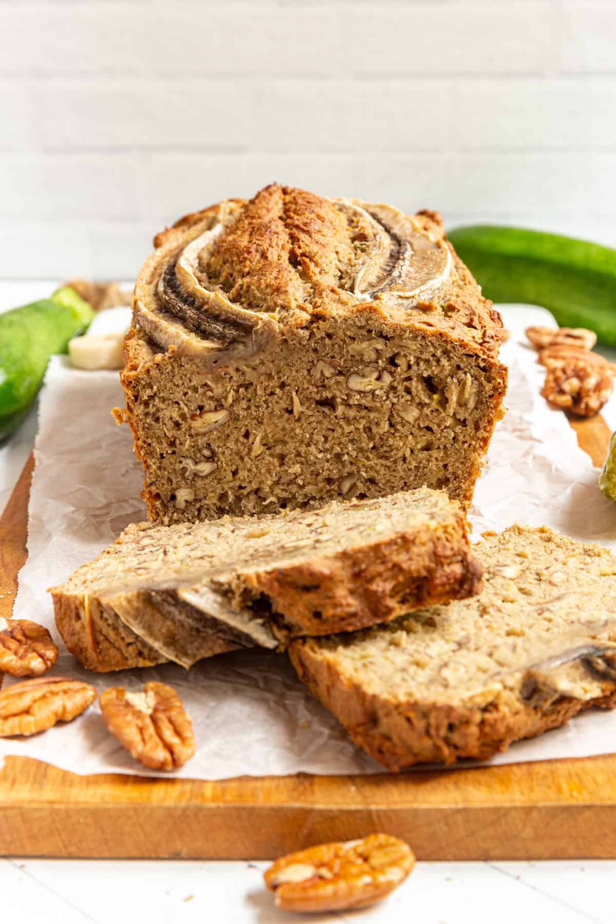 Two slices cut from a loaf of Vegan Banana Zucchini Bread.