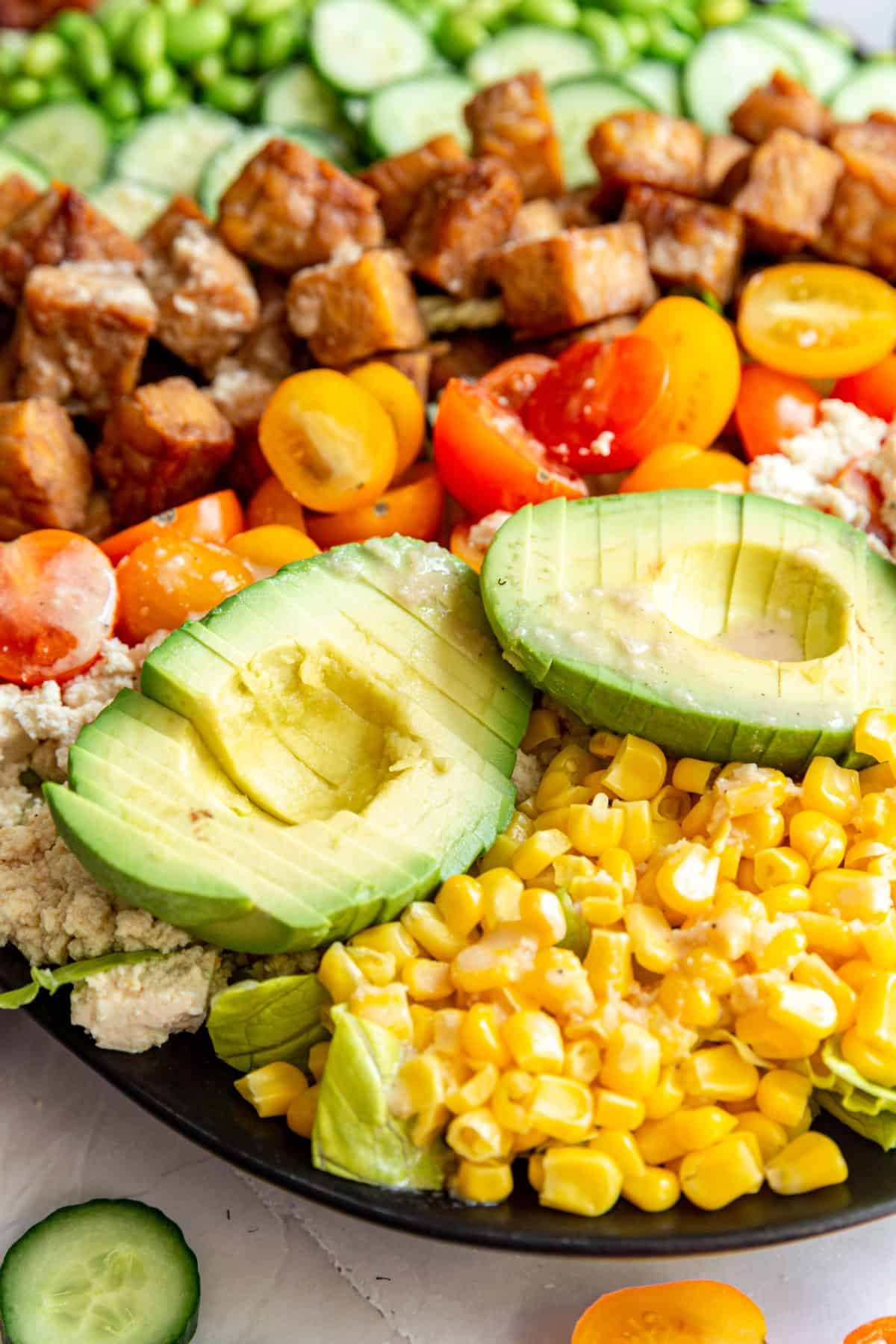 A close up view of the sliced avocados on the Vegan Cobb Salad.