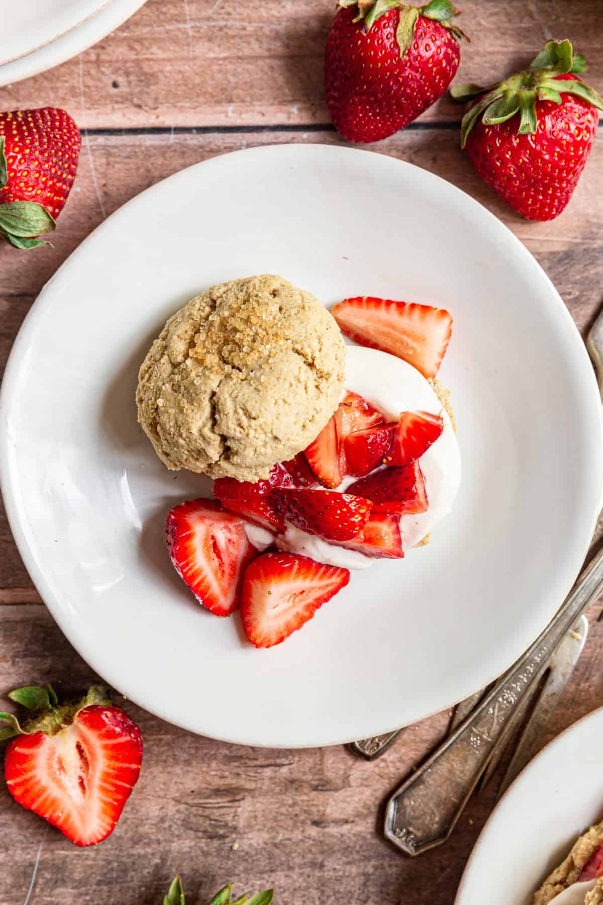 A top down view of a Gluten-Free Vegan Strawberry Shortcake overflowing with strawberries.