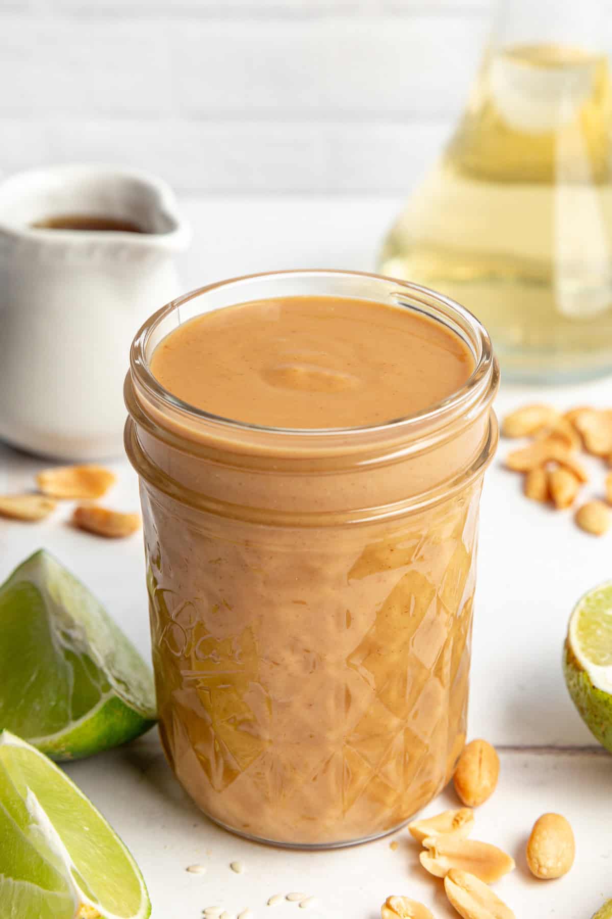 A jar of Healthy Peanut Sesame Dressing, ready to serve.