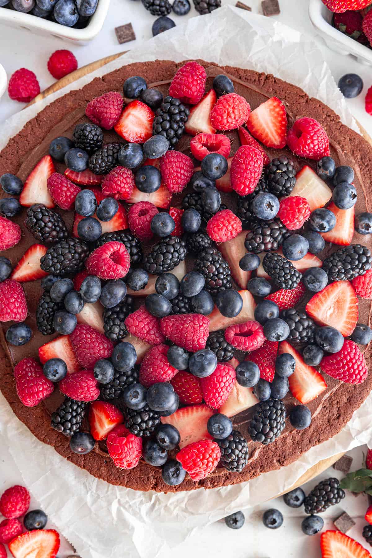 Vegan Chocolate Fruit Pizza surrounded by fruit.