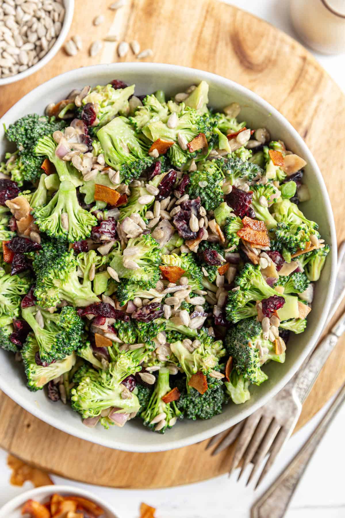 A bowl of Vegan Broccoli Salad served with extra sunflower seeds.