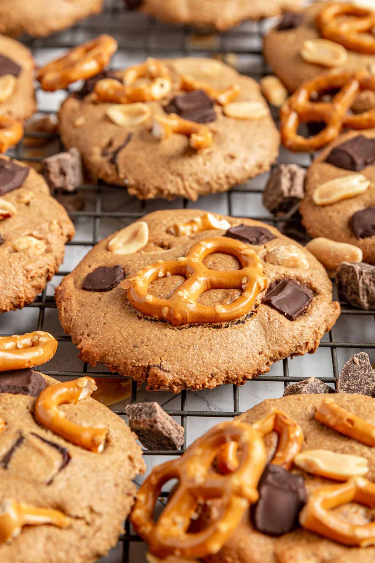 A batch of Vegan Kitchen Sink Cookies on a wire rack.