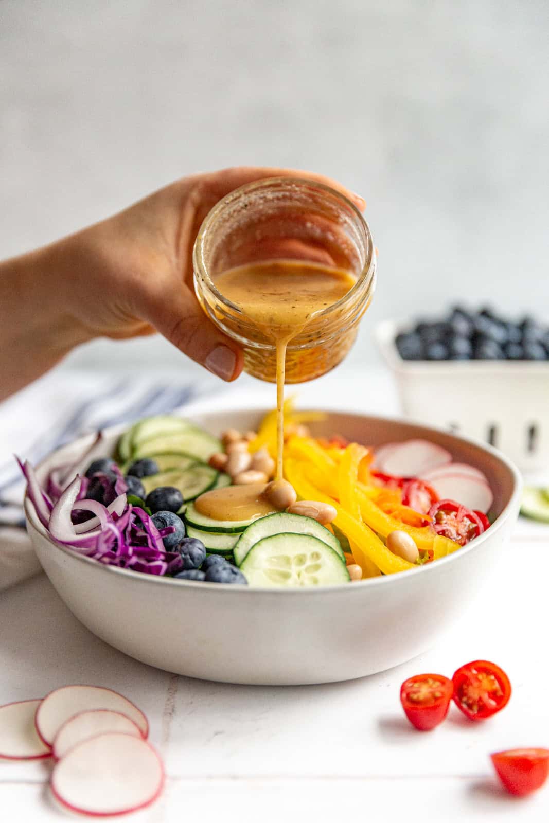 Easy Oil-Free Salad Dressing poured onto rainbow salad