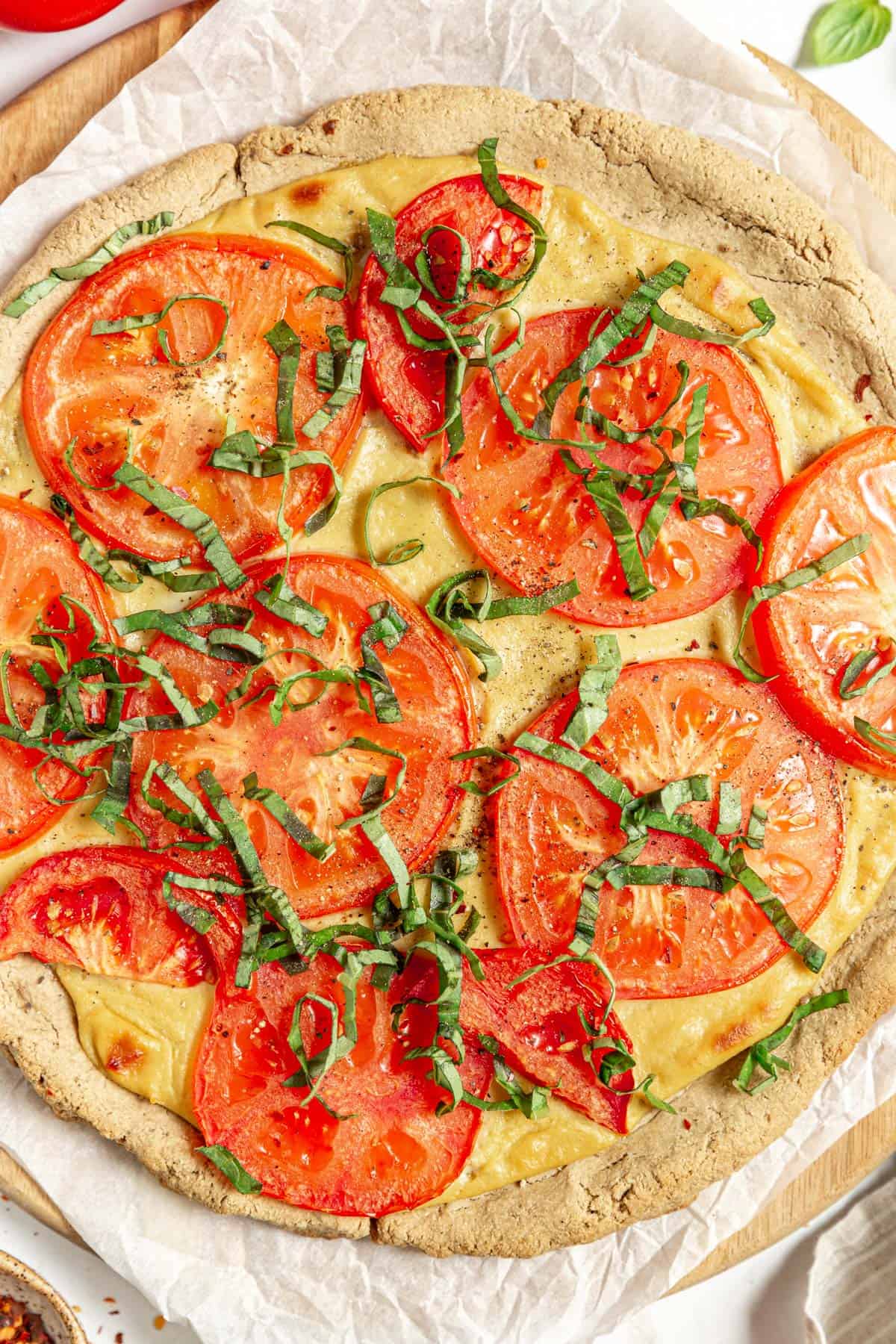 Oil-Free Vegan Oat Flour Pizza Crust (No Yeast) with tofu mozzarella, tomatoes, and basil.