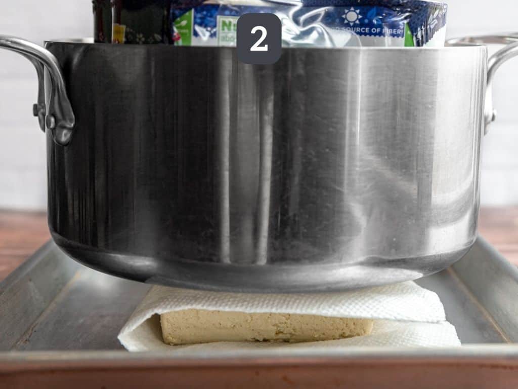 Air Fryer Tofu Nuggets Step 2 - press tofu under heavy object.
