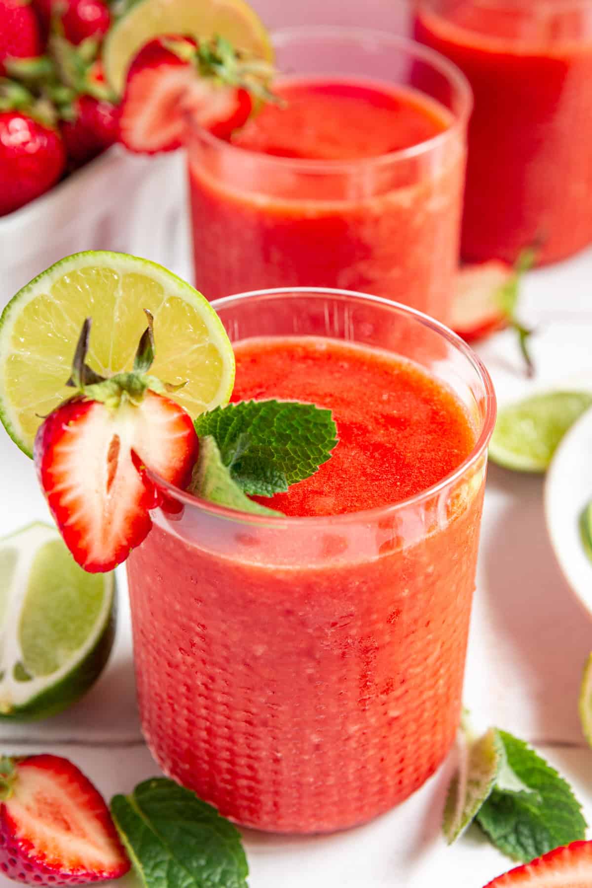 Strawberry Daiquiri Mocktail garnished with lime, strawberry, and mint.