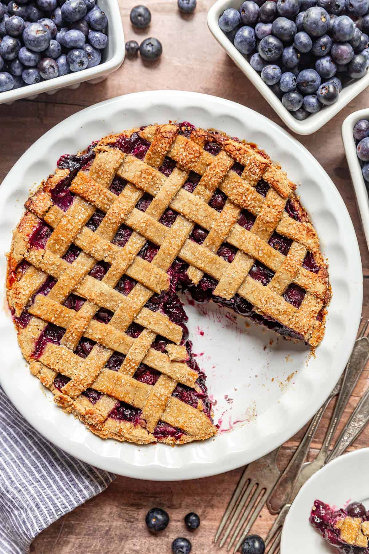 A Gluten Free Vegan Blueberry Pie with a slice removed and plated.