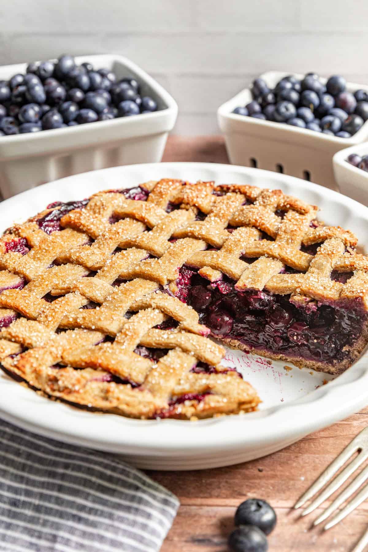 A Gluten Free Vegan Blueberry Pie with a slice removed.