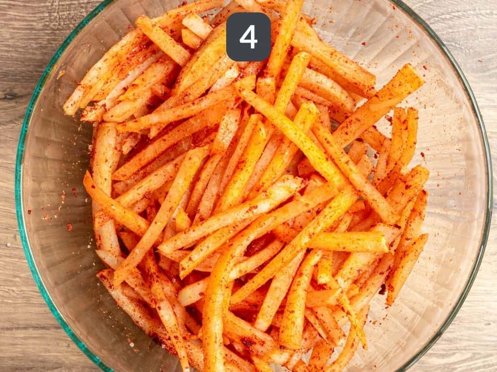 Jicama air fryer fries step 4 - toss with the spices.