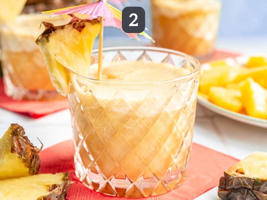 Piña Colada Mocktail Step 2 - serve with a garnish of pineapple and a tiny umbrella.