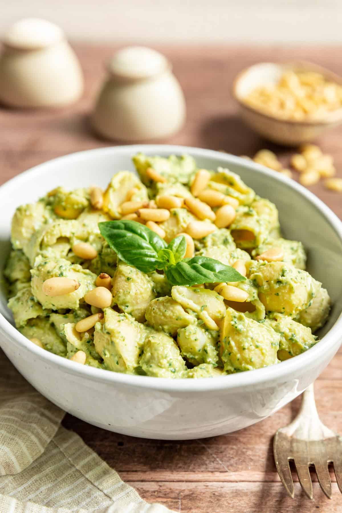 A bowl of Vegan White Bean Pesto Dip tossed with pasta.