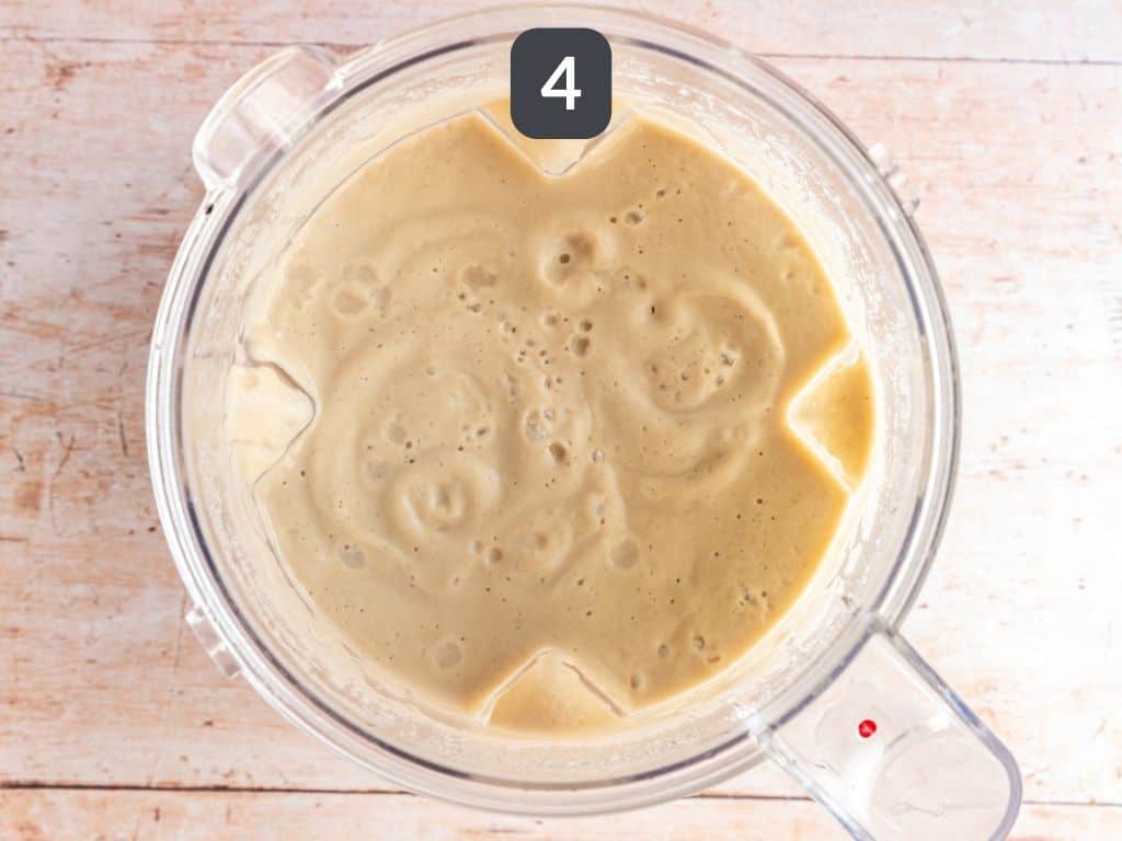 Creamy Cauliflower White Bean Soup Step 4 - soup blended in a blender.