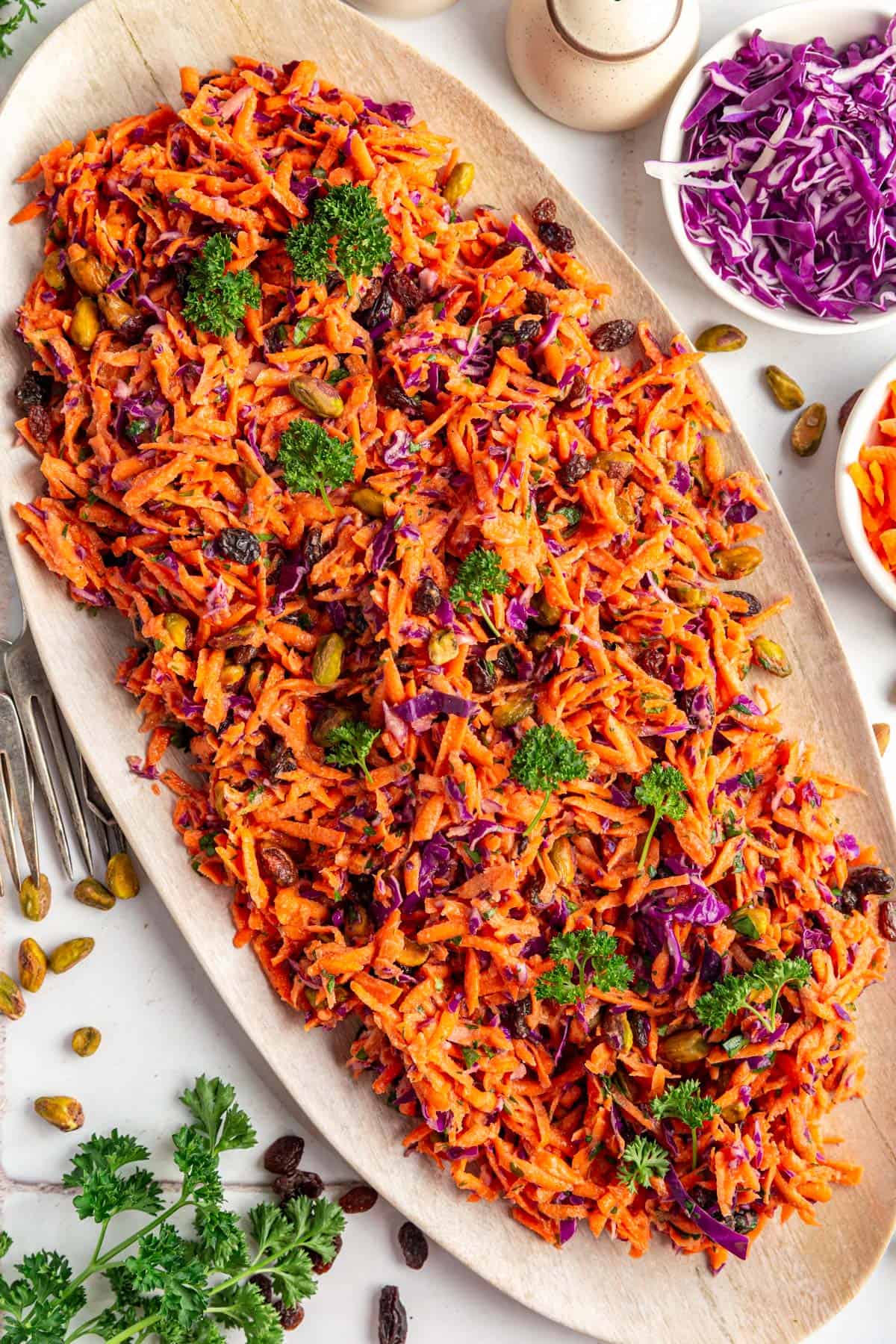 Carrot Raisin Salad garnished with curly parsley.