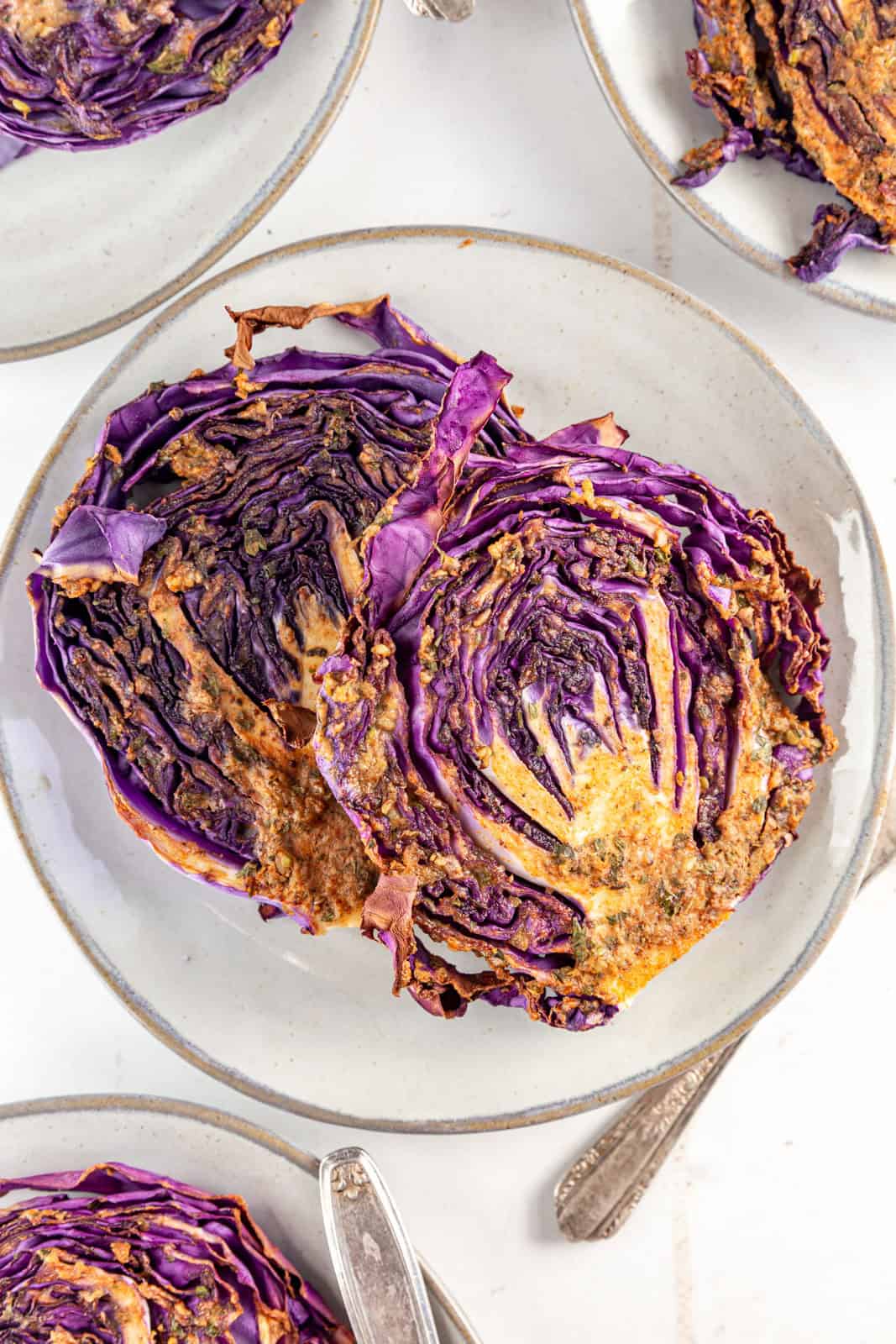 Two Red Cabbage Steaks served together on a plate.