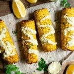 Air fryer corn on the cob topped with vegan aioli.
