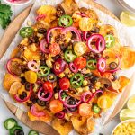 A tray of air fryer sweet potato nachos, loaded with toppings.