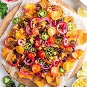 A tray of air fryer sweet potato nachos, loaded with toppings.