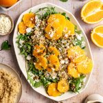 A platter of arugula citrus salad, with fresh oranges and extra quinoa.