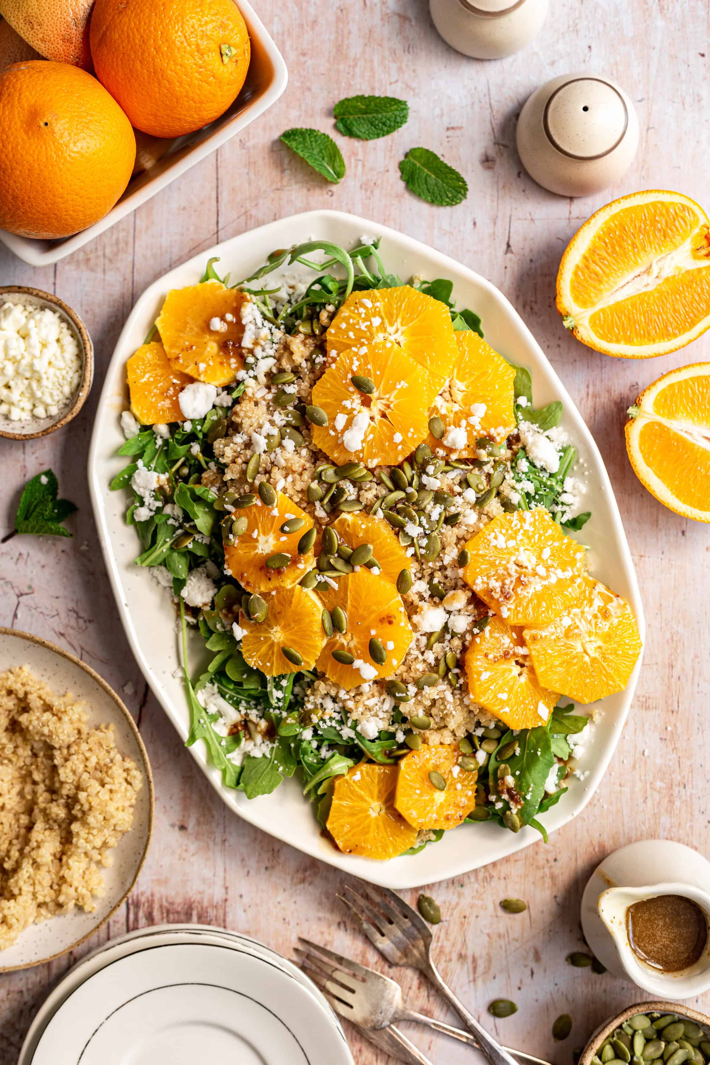 A platter of arugula citrus salad, with fresh oranges and extra quinoa.