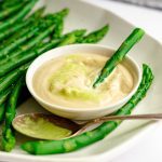 A spear of asparagus dipped in wasabi mayo.