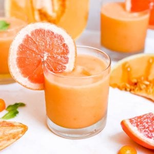 A cantaloupe cocktail garnished with a grapefruit slice.