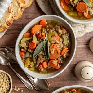 A bowl of carrot and lentil soup ready to eat.
