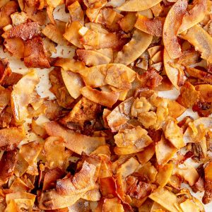 A baking sheet full of coconut bacon.
