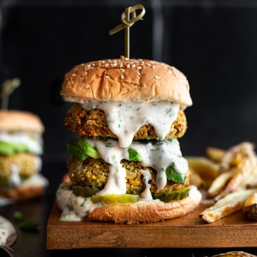 A double decker green goddess burger, dripping with green goddess dressing.
