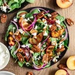 A plate of grilled plum spinach salad.