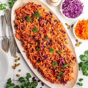 A large platter of carrot raisin salad.